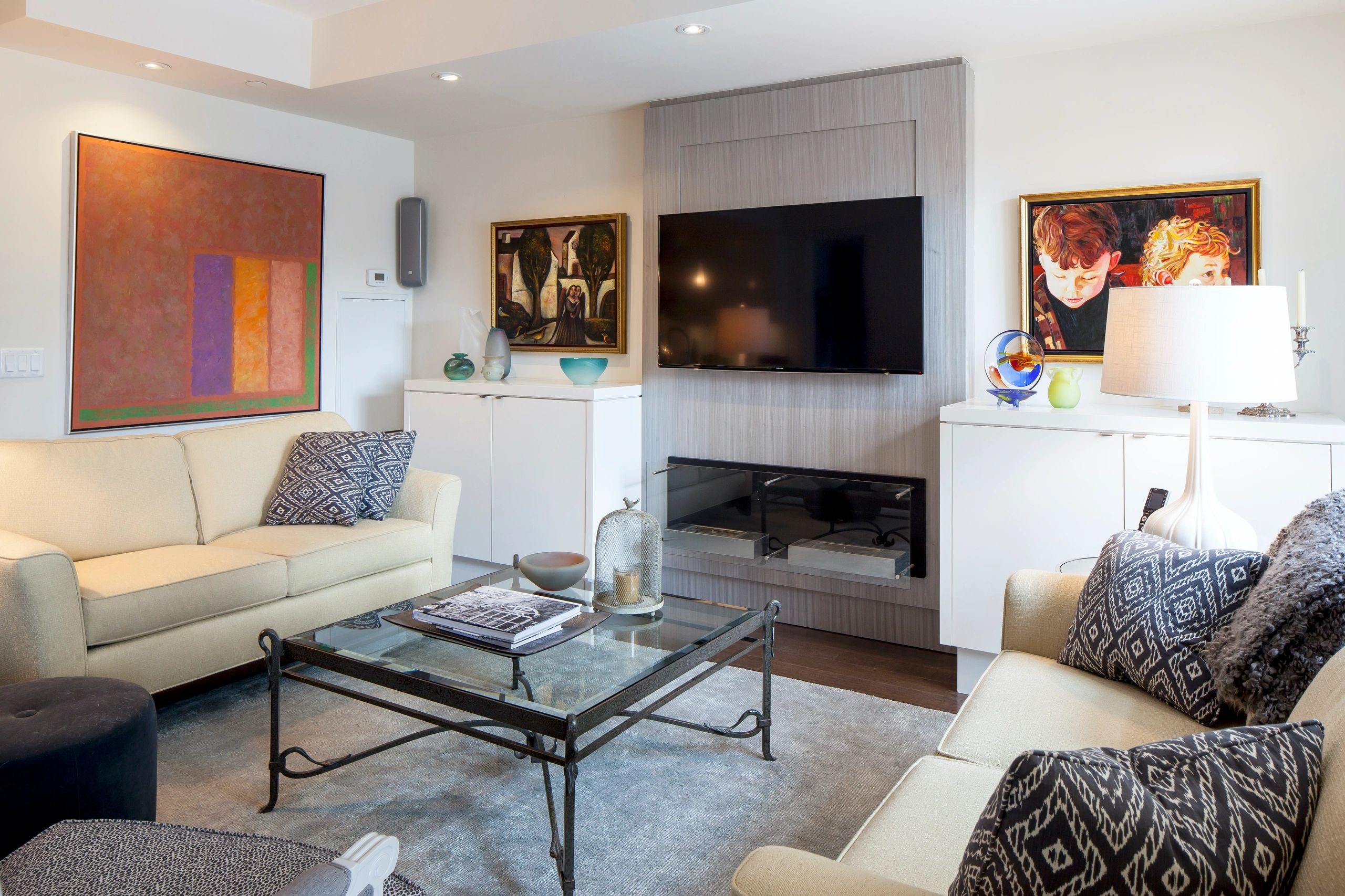 Living room with cream sofas and glass coffee table